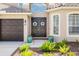 Elegant double front doors with decorative wreaths, complemented by lush greenery at 1178 Fraser Pine Blvd, Sarasota, FL 34240
