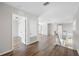 Hallway with wood floors and access to stairs and bedrooms at 1178 Fraser Pine Blvd, Sarasota, FL 34240