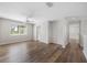 Open hallway with hardwood floors, view of yard from large window at 1178 Fraser Pine Blvd, Sarasota, FL 34240
