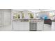 Bright kitchen featuring granite countertops, stainless steel appliances, and ample white cabinetry at 1178 Fraser Pine Blvd, Sarasota, FL 34240