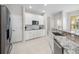 Bright kitchen with stainless steel appliances, granite countertops, and white cabinetry at 1178 Fraser Pine Blvd, Sarasota, FL 34240