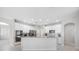 A bright kitchen boasts white cabinetry, modern stainless steel appliances, granite counters, and tiled flooring at 1178 Fraser Pine Blvd, Sarasota, FL 34240