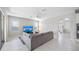 Bright living room showcasing a large TV, neutral colored sectional sofa, and sun-filled windows at 1178 Fraser Pine Blvd, Sarasota, FL 34240