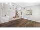 Open-concept living room with staircase, beautiful floors, and elegant chandelier at 1178 Fraser Pine Blvd, Sarasota, FL 34240