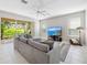 Cozy living room featuring a comfortable sectional sofa and access to the backyard at 1178 Fraser Pine Blvd, Sarasota, FL 34240