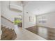 Inviting living room with staircase, tile/wood flooring, and large windows offering natural light at 1178 Fraser Pine Blvd, Sarasota, FL 34240