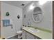 Well-lit bathroom featuring a vanity, toilet, decorative mirror, and updated flooring at 1207 Oak Valley Dr, Seffner, FL 33584