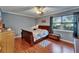 Cozy bedroom with wood floors, a ceiling fan, and a comfortable bed at 1207 Oak Valley Dr, Seffner, FL 33584