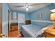 Cozy bedroom with a blue painted wall, wood flooring and a ceiling fan at 1207 Oak Valley Dr, Seffner, FL 33584