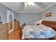Bedroom featuring wood floors, gray walls, and matching wood furniture at 1207 Oak Valley Dr, Seffner, FL 33584