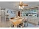 Bright dining room featuring a ceiling fan, a large window, and seating for six at 1207 Oak Valley Dr, Seffner, FL 33584