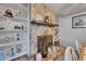 Close-up of the dining room's stone fireplace with built-in shelving and decor at 1207 Oak Valley Dr, Seffner, FL 33584