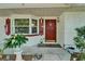 Inviting front porch with a bay window, brick facade, and a cheerful red front door at 1207 Oak Valley Dr, Seffner, FL 33584
