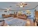 Spacious living room with hardwood floors, ceiling fans, and comfortable seating arrangements at 1207 Oak Valley Dr, Seffner, FL 33584
