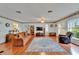 Inviting living room featuring hardwood floors, a large TV, and a ceiling fan at 1207 Oak Valley Dr, Seffner, FL 33584