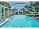Backyard swimming pool with patio, surrounded by lush landscaping and mature trees for privacy and relaxation at 1207 Oak Valley Dr, Seffner, FL 33584