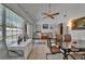 Bright sun room with lots of windows, tile flooring, a ceiling fan and glass doors leading to the pool at 1207 Oak Valley Dr, Seffner, FL 33584