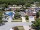 Neighborhood aerial view showcasing a well-kept home with mature trees and neighboring properties at 12506 Twisted Oak Dr, Tampa, FL 33624
