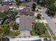 Aerial view of home with neutral roof, fenced backyard, and lush landscaping in a residential neighborhood at 12506 Twisted Oak Dr, Tampa, FL 33624
