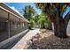 Paver patio leads to a screened-in lanai and features lush landscaping and shade trees at 12506 Twisted Oak Dr, Tampa, FL 33624