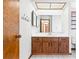Bathroom featuring a wood vanity with a large mirror, and coat hooks at 12506 Twisted Oak Dr, Tampa, FL 33624