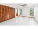 Bright bedroom featuring large closet space, ceiling fan, and tiled floor at 12506 Twisted Oak Dr, Tampa, FL 33624