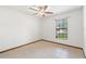 Simple bedroom with a window providing natural light and tile flooring at 12506 Twisted Oak Dr, Tampa, FL 33624