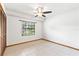 Cozy bedroom with a window, a ceiling fan, and tile flooring at 12506 Twisted Oak Dr, Tampa, FL 33624