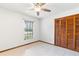 Bedroom featuring a ceiling fan, tile flooring, and large closet space at 12506 Twisted Oak Dr, Tampa, FL 33624
