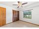 Bedroom featuring a ceiling fan, tile flooring, and large closet space at 12506 Twisted Oak Dr, Tampa, FL 33624