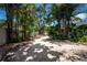 Paver driveway is lined with rocks, landscaping and mature trees at 12506 Twisted Oak Dr, Tampa, FL 33624