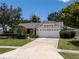 Charming single-story home featuring a well-manicured lawn and an attached two-car garage at 12506 Twisted Oak Dr, Tampa, FL 33624