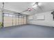 Spacious garage with epoxy flooring, white cabinets, and a garage door at 12506 Twisted Oak Dr, Tampa, FL 33624