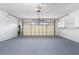 Spacious two car garage with ample lighting, storage, and epoxy flooring at 12506 Twisted Oak Dr, Tampa, FL 33624