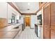 Bright kitchen featuring tile countertops, wooden beams, and stainless steel appliances at 12506 Twisted Oak Dr, Tampa, FL 33624