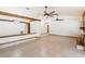 View of an open-concept living room with tile floors, wood beams, and recessed lighting at 12506 Twisted Oak Dr, Tampa, FL 33624