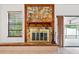 Living room featuring a stone fireplace, a wooden mantel, and access to the patio at 12506 Twisted Oak Dr, Tampa, FL 33624