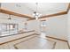 Open-concept living area with tile flooring, exposed beams, and natural light throughout at 12506 Twisted Oak Dr, Tampa, FL 33624