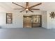 This covered lanai features a ceiling fan, access to interior, and backyard views at 12506 Twisted Oak Dr, Tampa, FL 33624