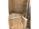 Bathroom with a corner bathtub and tiled shower with glass door at 12820 Belvedere Song Way Way, Riverview, FL 33578