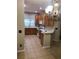 Well-lit kitchen with tile flooring, wooden cabinets, and white appliances at 12820 Belvedere Song Way Way, Riverview, FL 33578