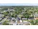 Aerial view of neighborhood highlighting the modern home and mature trees at 1413 E 108Th Ave, Tampa, FL 33612