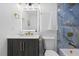 Stylish bathroom featuring marble tiled shower, modern vanity, and gold fixtures and accents at 1413 E 108Th Ave, Tampa, FL 33612