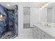Bathroom showing marble tile shower, modern vanity with gold hardware, and gray laminate flooring at 1413 E 108Th Ave, Tampa, FL 33612