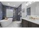 Beautiful bathroom showcasing modern fixtures, a soaking tub, a vanity, and marble walls at 1413 E 108Th Ave, Tampa, FL 33612