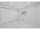 Minimalist bedroom featuring recessed lights, marble floors and a closet at 1413 E 108Th Ave, Tampa, FL 33612