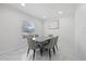 Modern dining room featuring a marble table, stylish chairs, and a window offering natural light at 1413 E 108Th Ave, Tampa, FL 33612