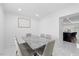 Stylish dining room with marble table, modern chairs, and a view leading into the kitchen area at 1413 E 108Th Ave, Tampa, FL 33612