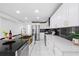 Spacious kitchen with stainless steel appliances, a large black countertop island, and white cabinetry at 1413 E 108Th Ave, Tampa, FL 33612
