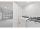 Laundry area featuring a new white washer and dryer at 1413 E 108Th Ave, Tampa, FL 33612